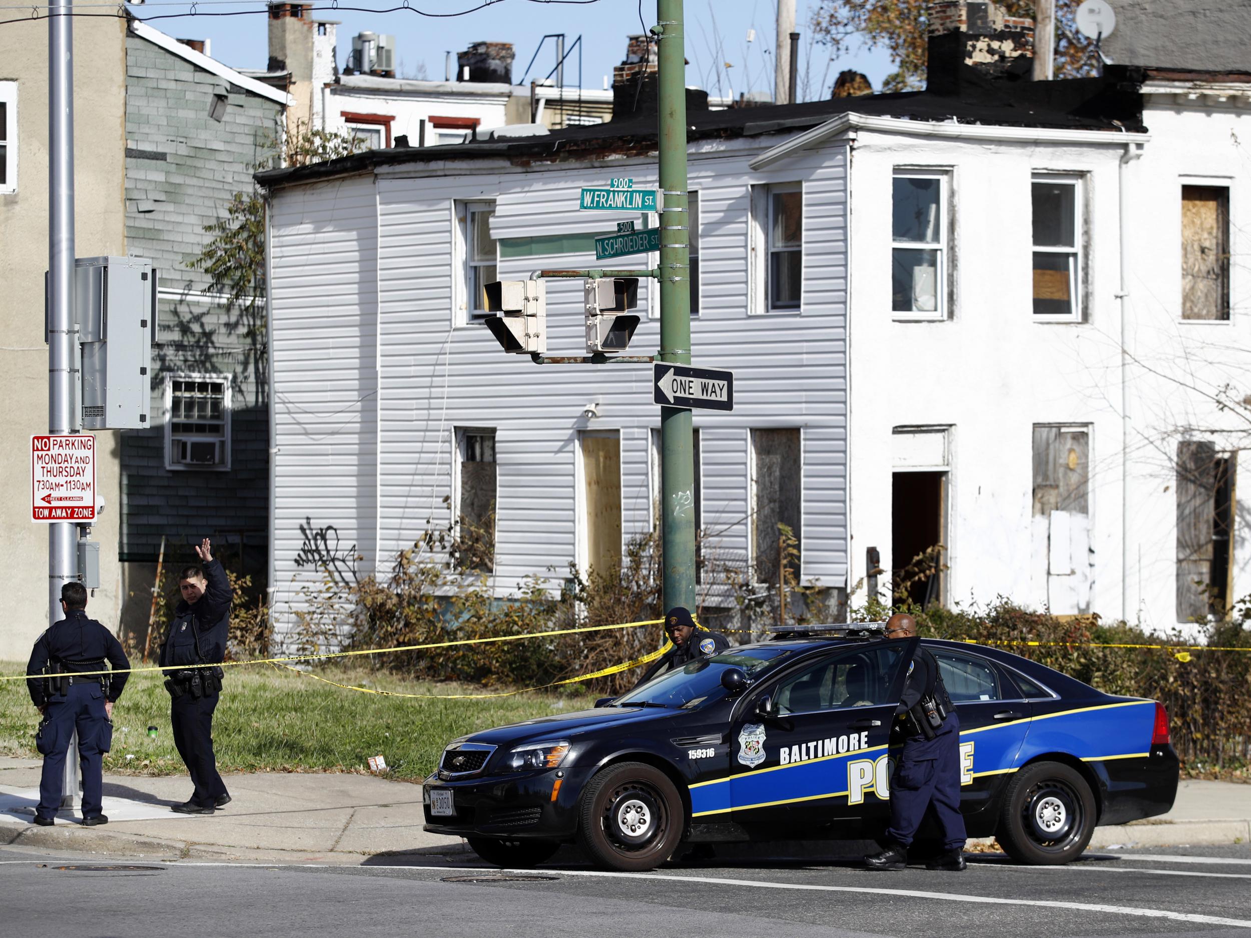 Members of the Baltimore Police Department gather near the scene of the shooting death of Detective Sean Suiter