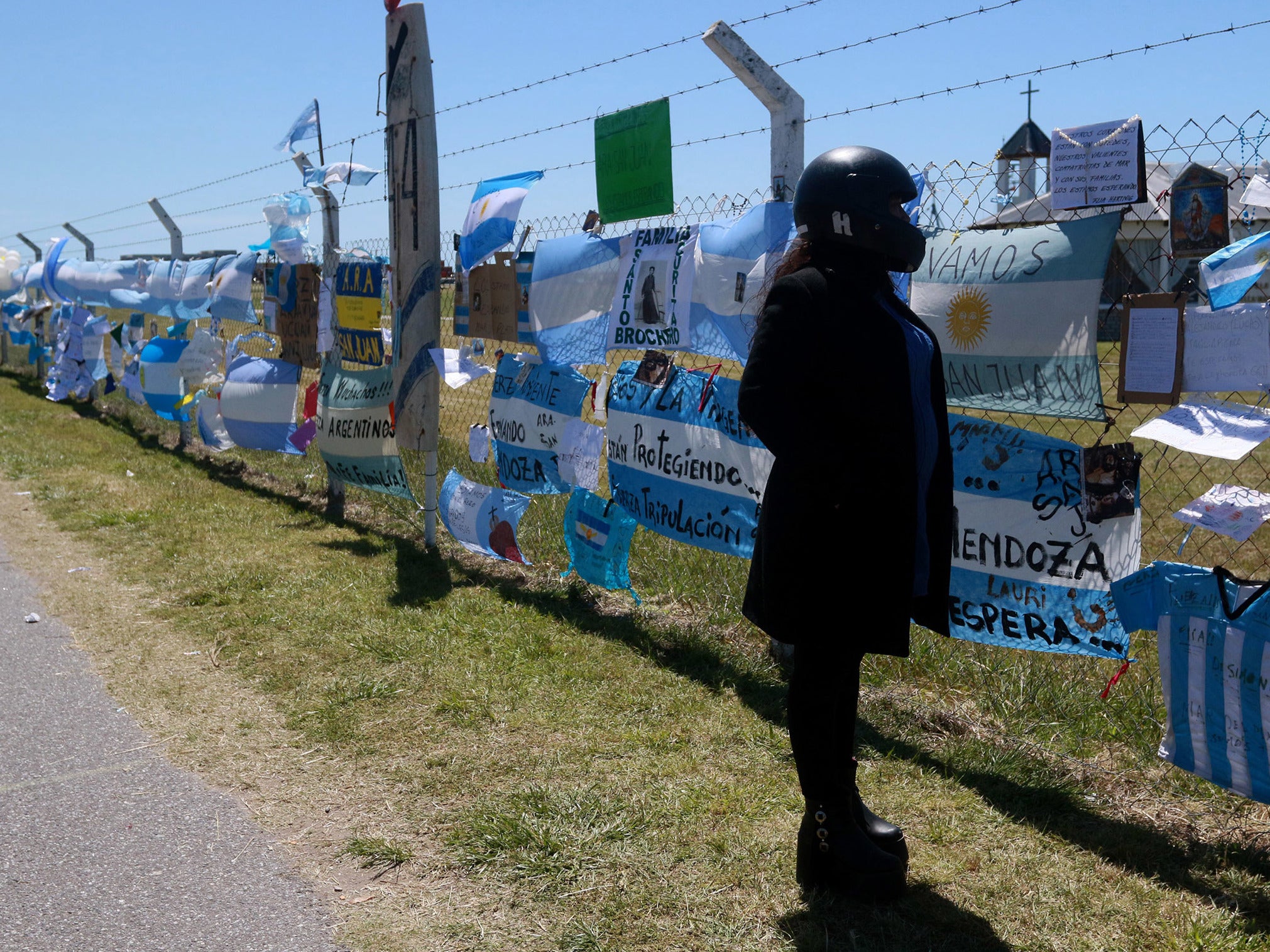 A woman reads the messages dedicated to the 44 crew members of the missing submarine ARA San Juan