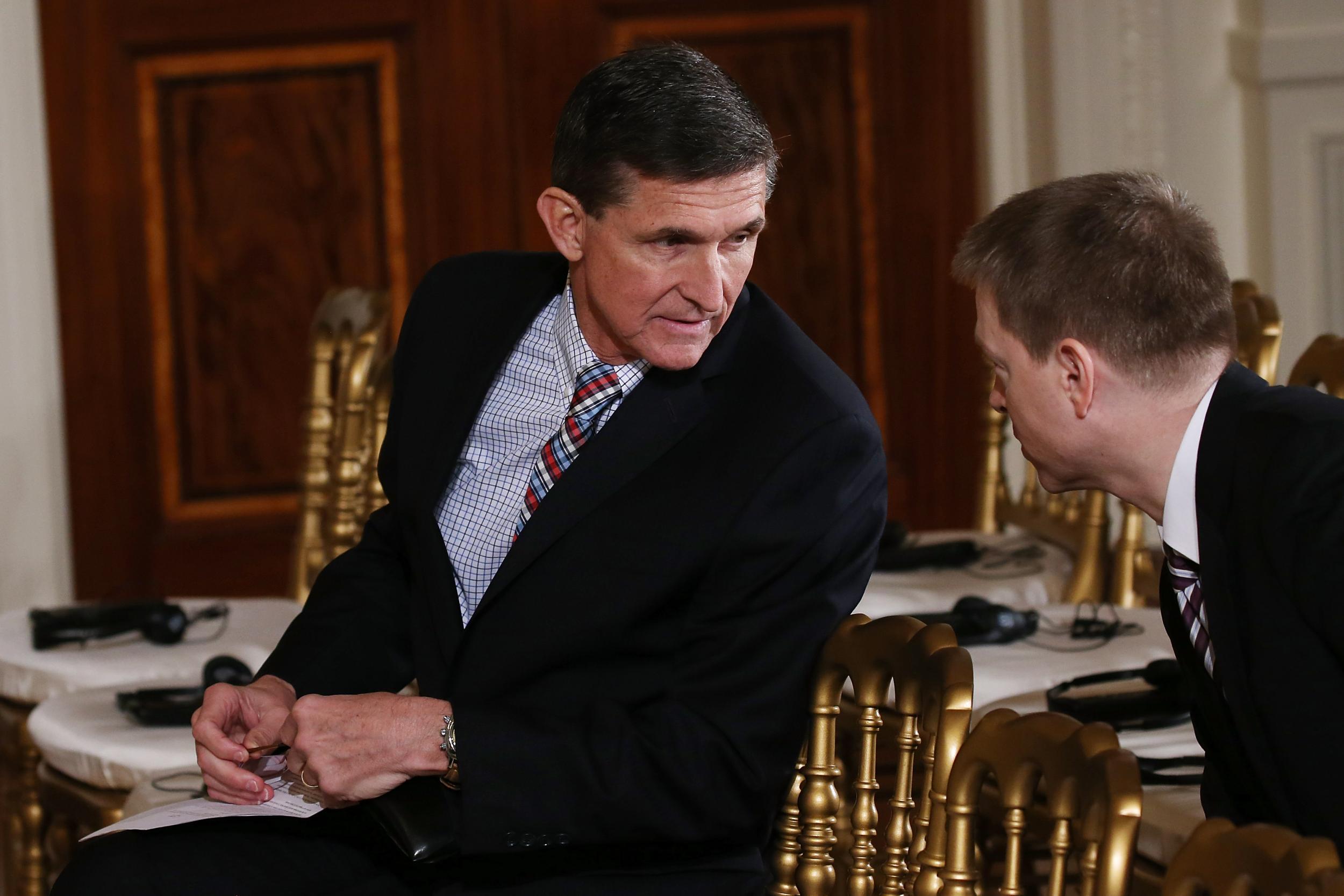 Former National Security Adviser Michael Flynn sits before US President Donald Trump and Japanese Prime Minister Shinzo Abe hold a joint press conference