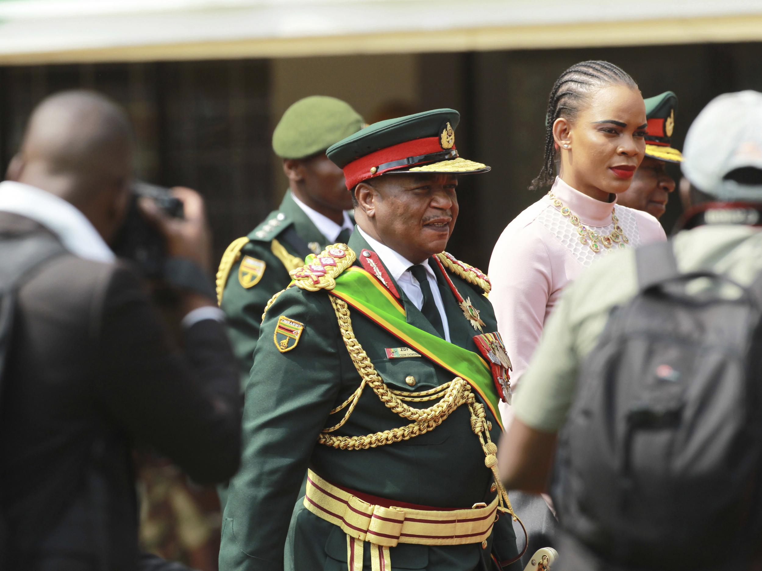 Army General Constantino Chiwenga, center, arrives with his wife Mary at the presidential inauguration ceremony of Emmerson Mnangagwa in Harare