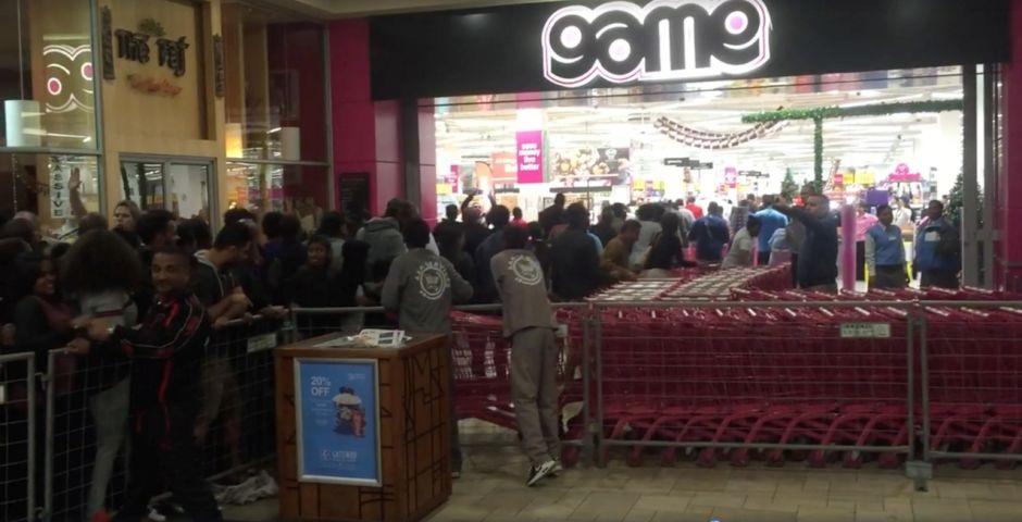 Shoppers queue in Durban, South Africa (Reuters)