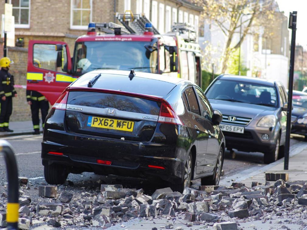 A mother and her baby had a narrow escape when rubble fell from the top of a tower block and into the road in Hackney, east London