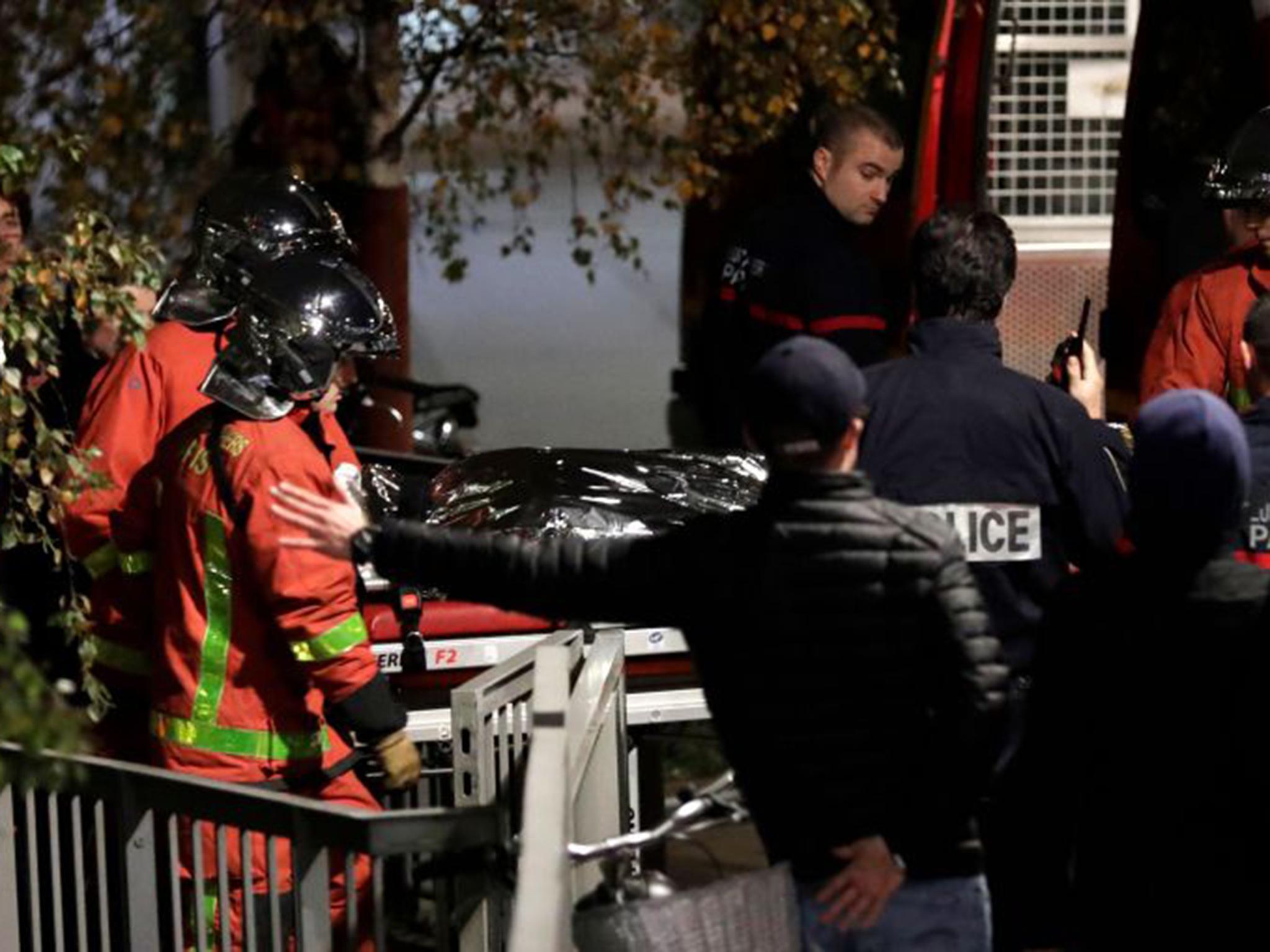 Police officials and rescue personnel transport the body of a tiger which had escaped from a circus into a vehicle