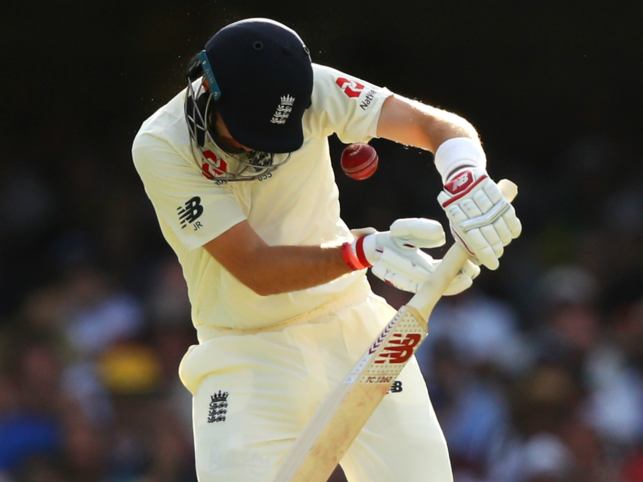 Joe Root is hit on the helmet by a Mitchell Starc bouncer