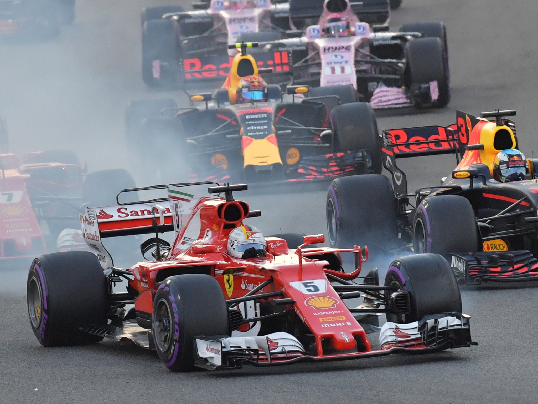 Sebastian Vettel locks up a tyre defending his position from Daniel Ricciardo