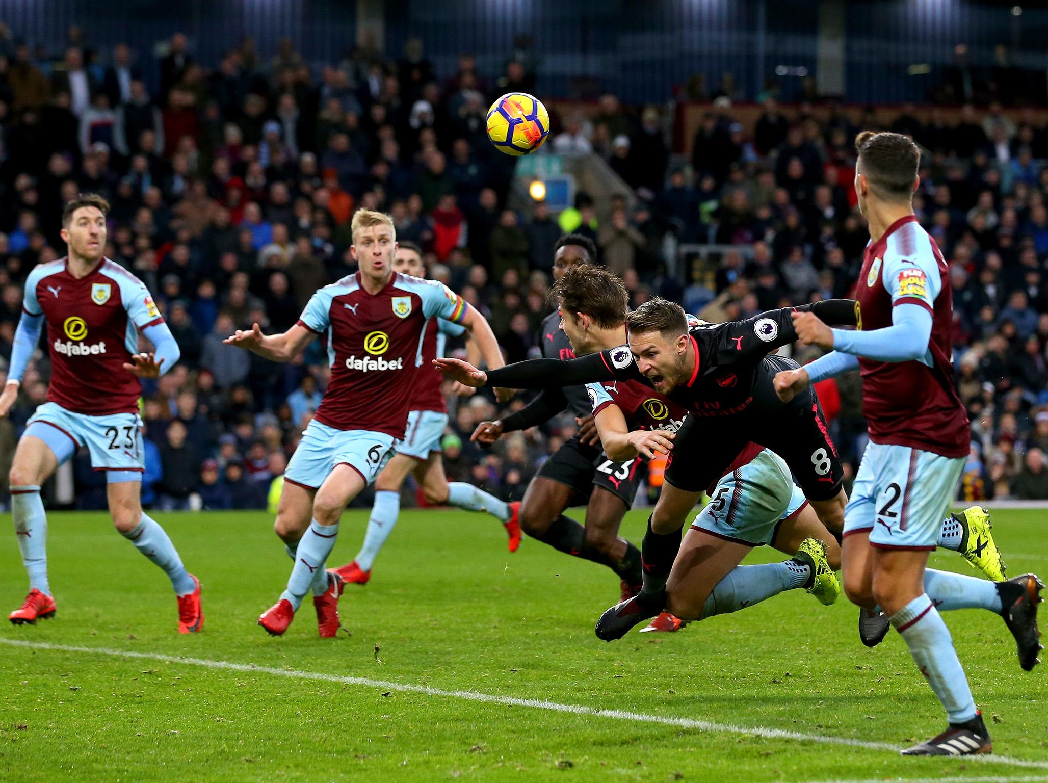 Aaron Ramsey goes to ground under a challenge by James Tarkowski