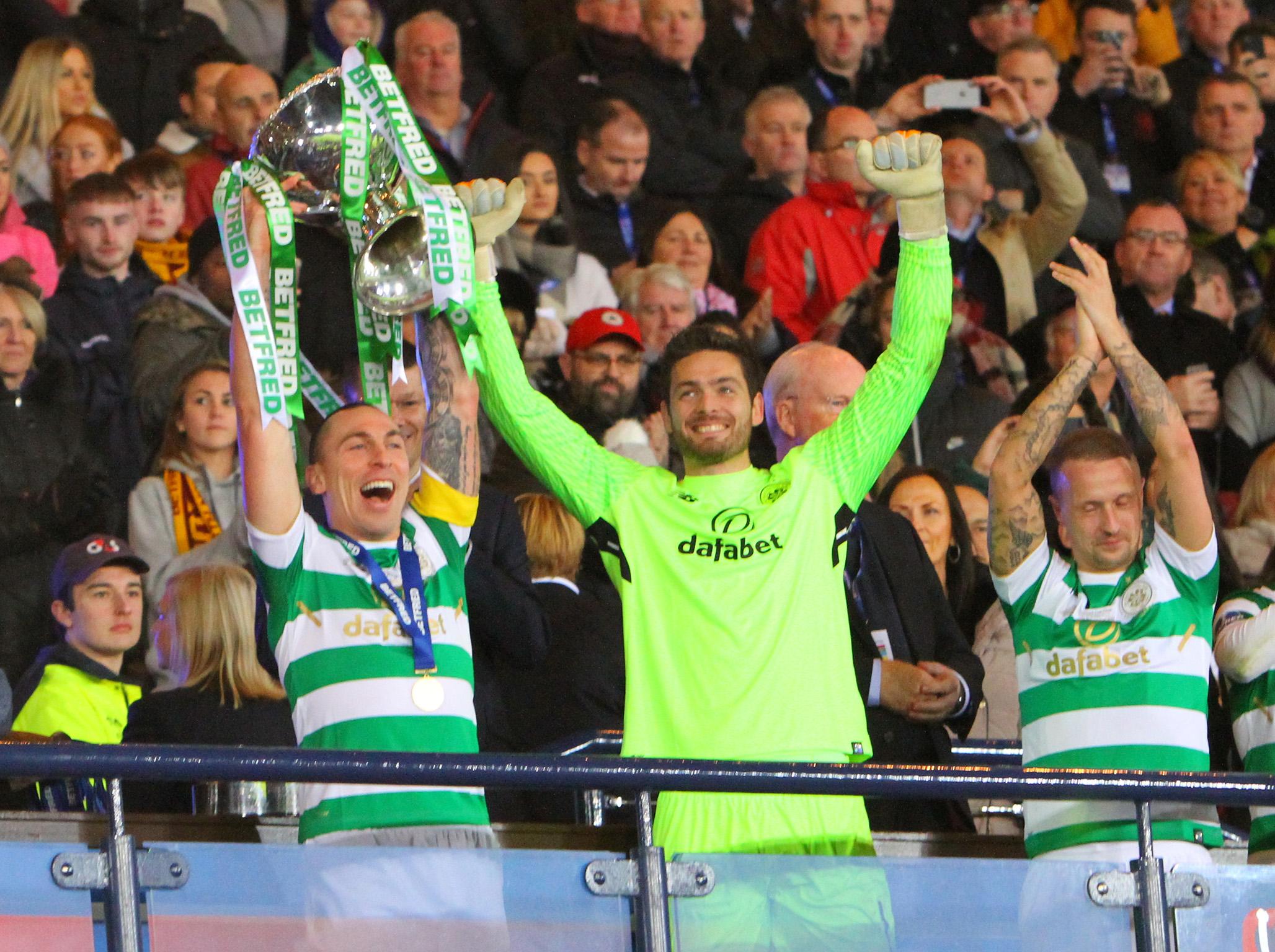 Celtic’s captain Scott Brown raises the trophy