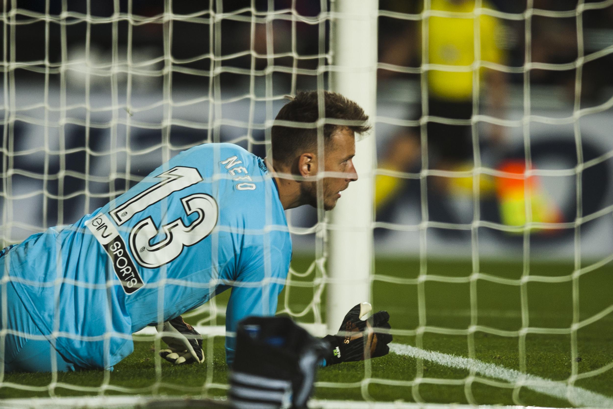 Valencia goalkeeper Neto spills over his own goal-line