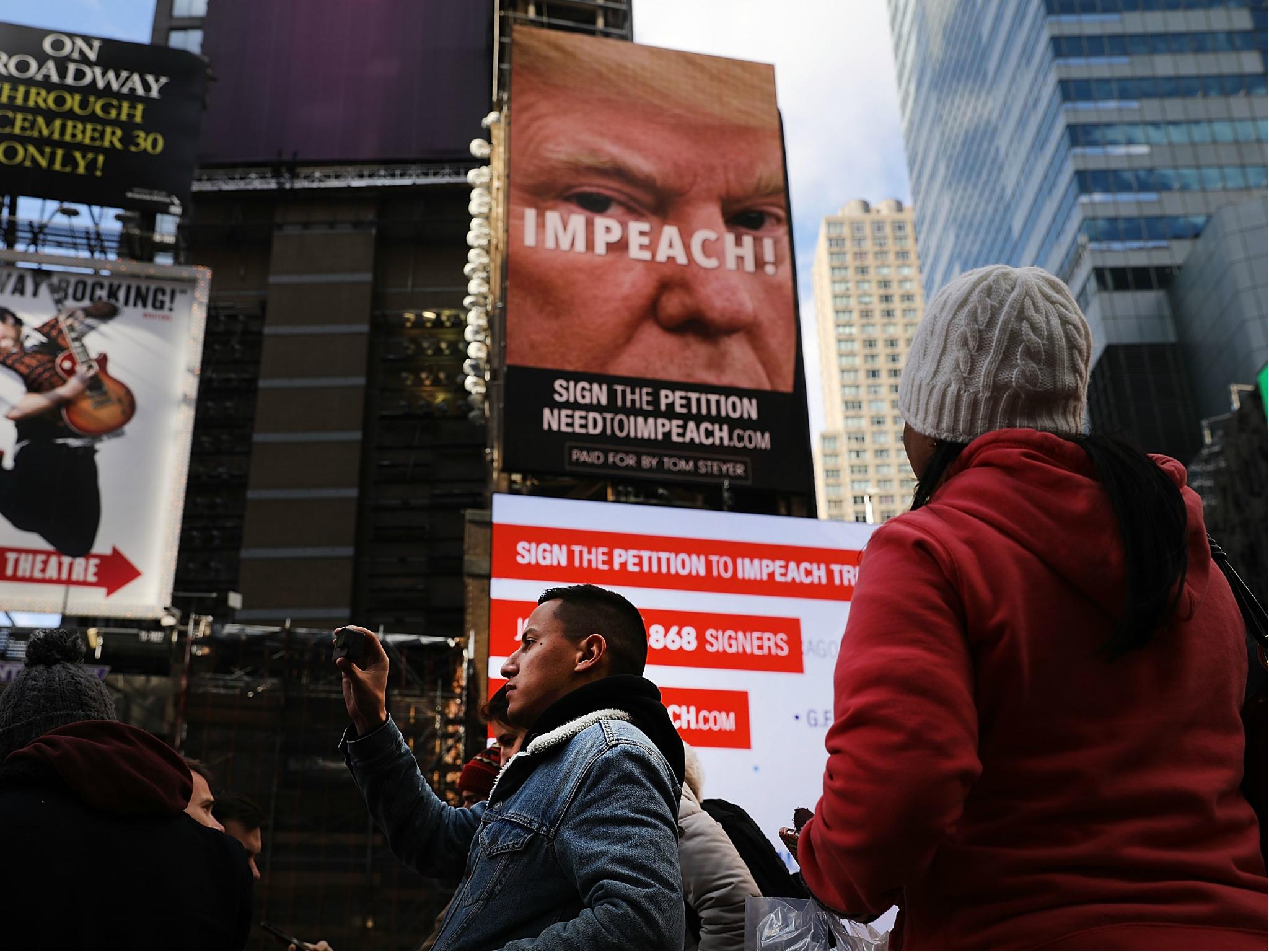 A billboard in Times Square, funded by Tom Steyer, calls for the impeachment of President Donald Trump on 20 November 2017 in New York City.