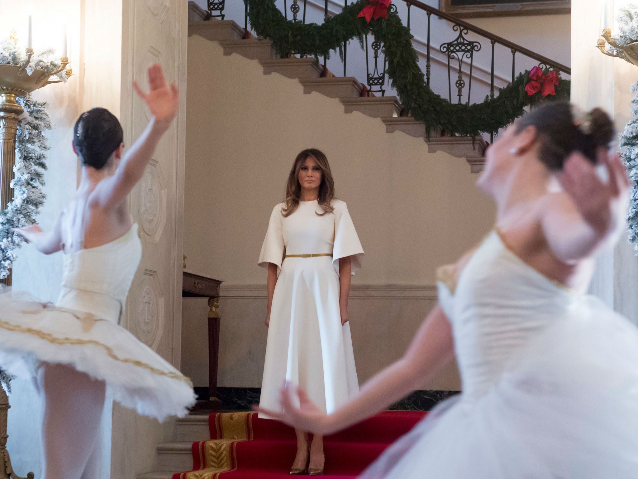 First Lady Melania Trump watches ballerinas perform during her 2017 tour of the White House Christmas decorations