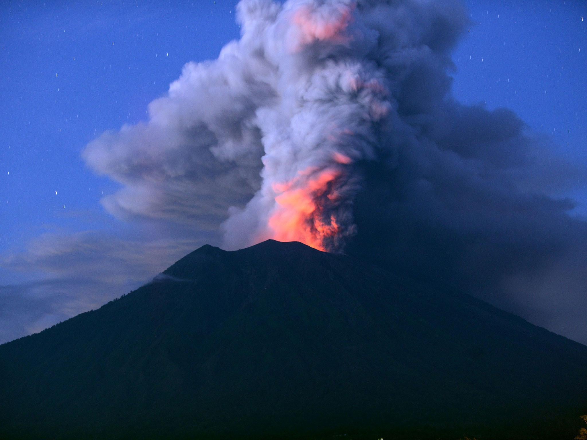 Mount Agung has stranded tens of thousands of tourists as it spits ash 4,000m (2.5 miles) into the air