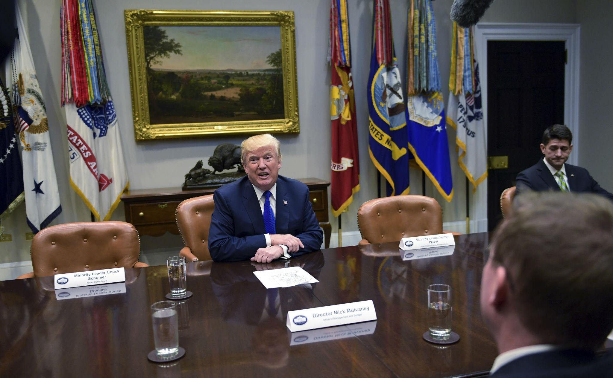 President Donald Trump, center speaks in the Roosevelt Room of the White House in Washington (AP Photo/Susan Walsh)