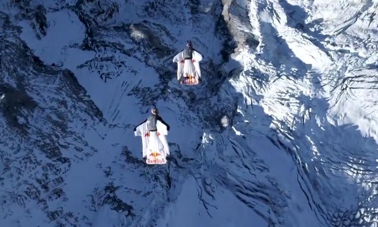 Two wingsuit flyers jump from Jungfrau mountain in Switzerland into moving plane