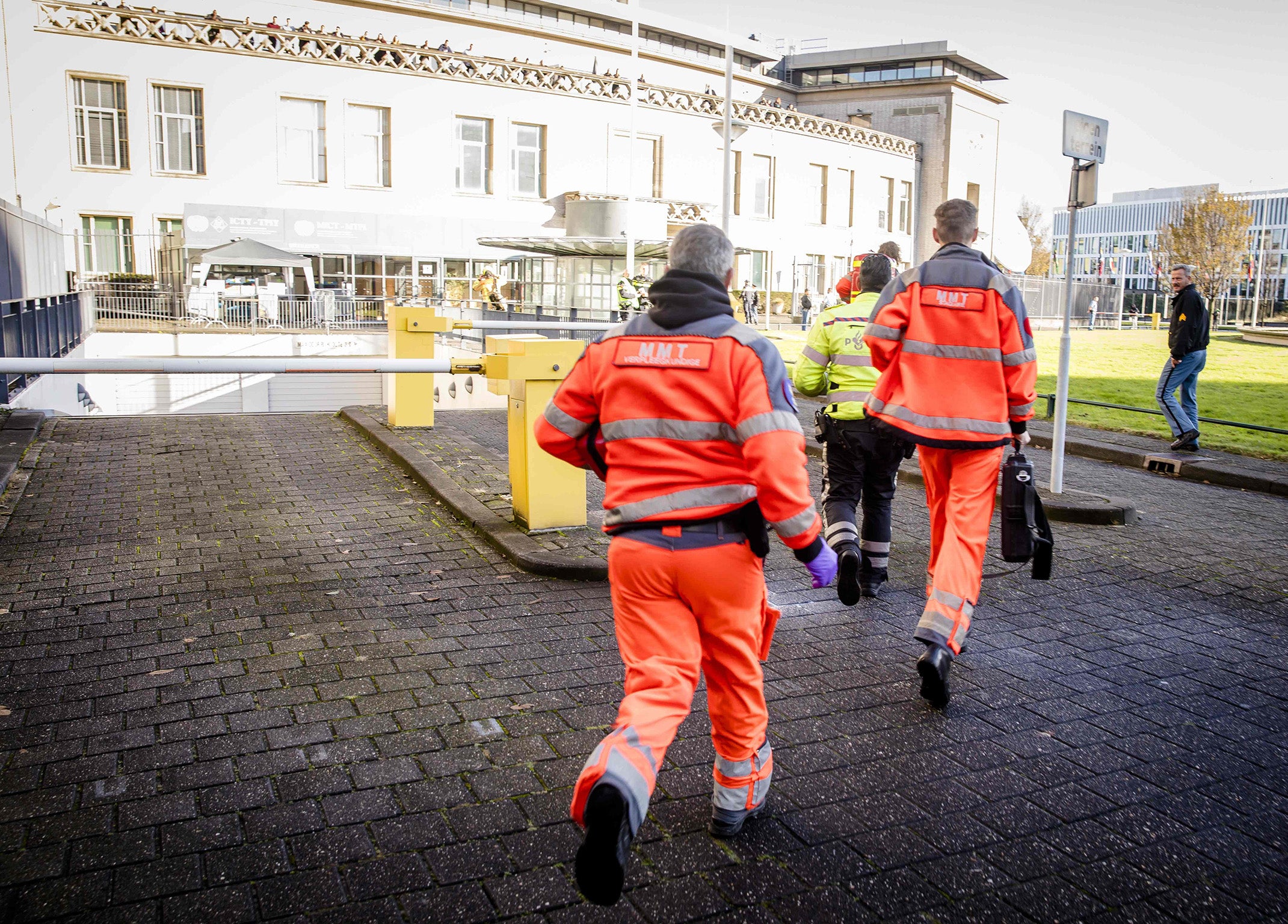 Emergency Services staff run toward The Hague after Slobodan Praljak apparently drank poison