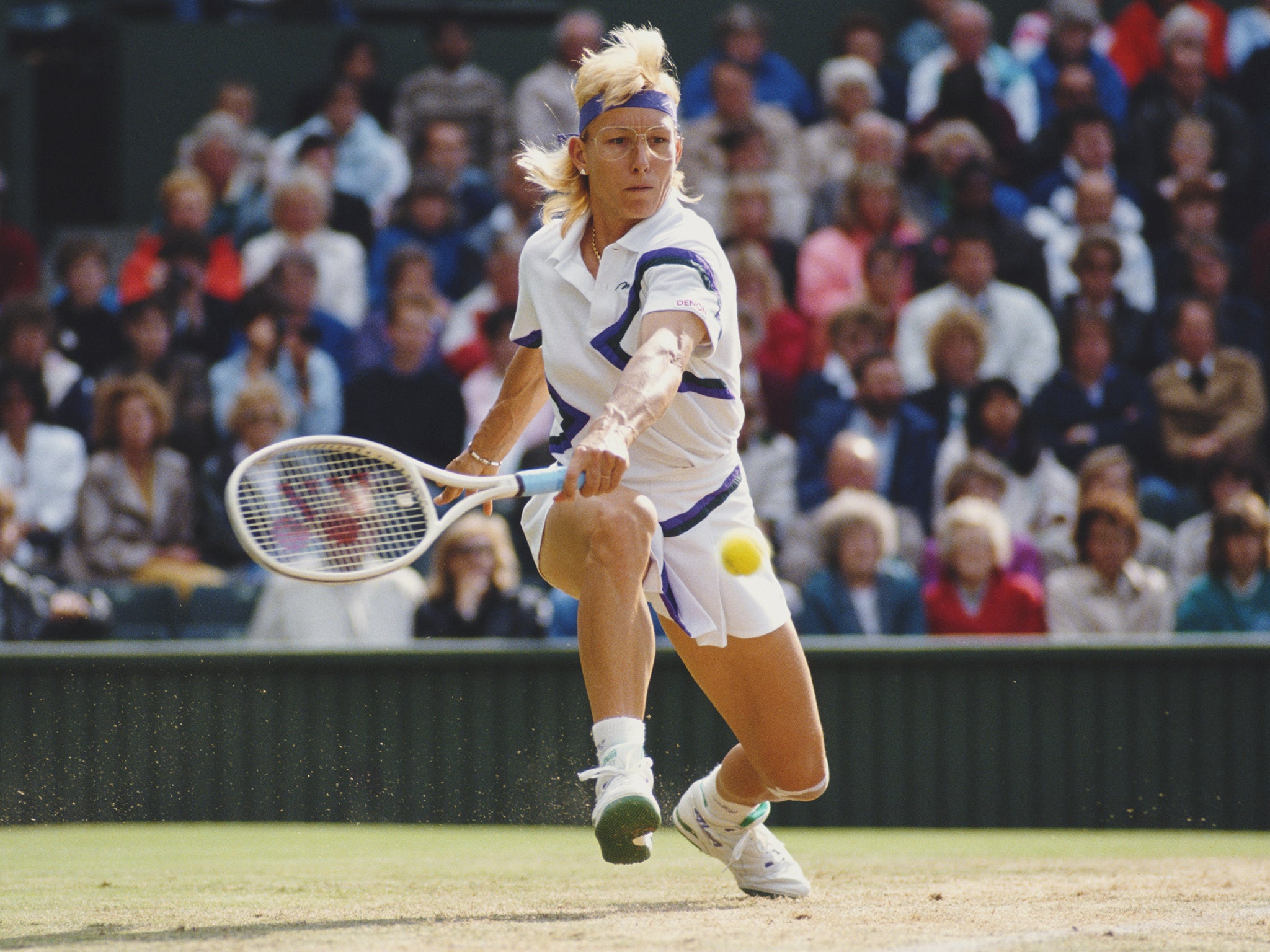 Martina Navratilova stretches to make a back hand return