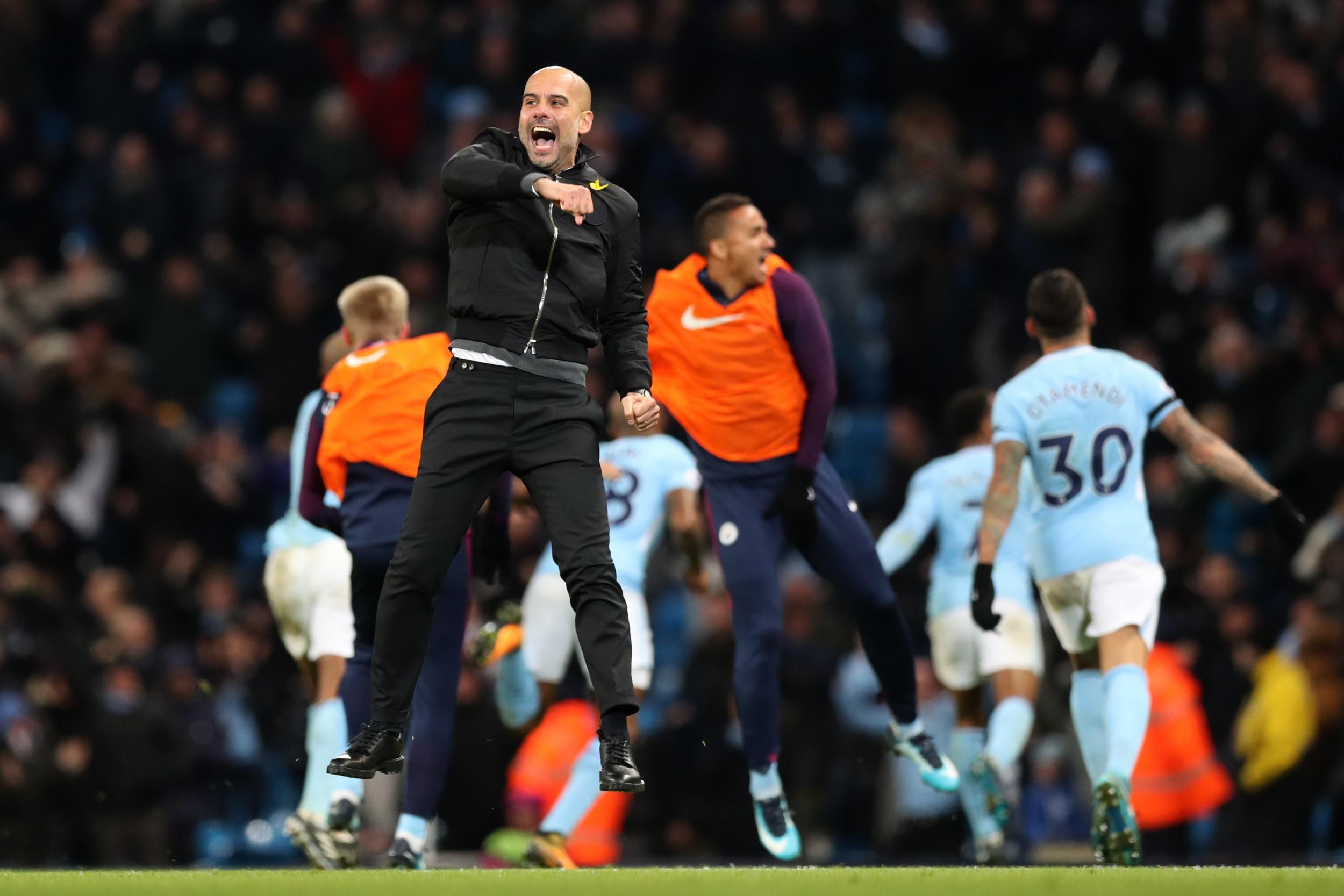 Pep Guardiola celebrates wildly after Raheem Sterling's winning goal