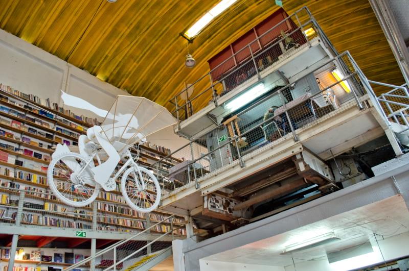 Ler Devagar book shop plays folk music and has bicycles suspended from the ceiling