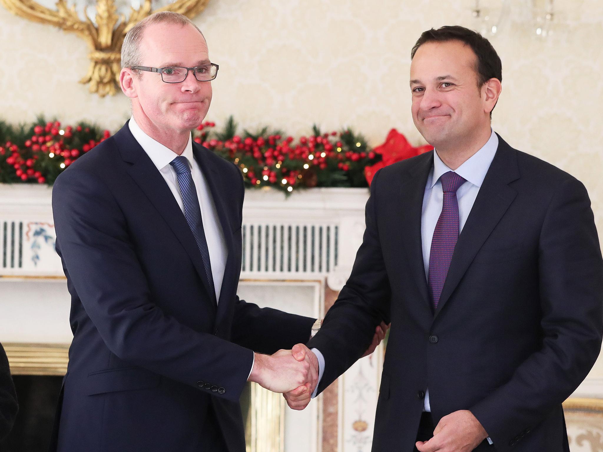 Simon Coveney shakes hands with Leo Vardkar after his appointment as Deputy Premier