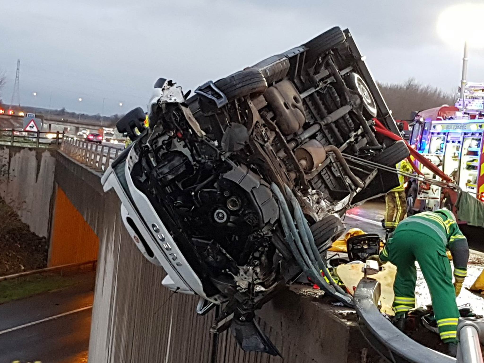 The van was balanced precariously over the edge of the bridge