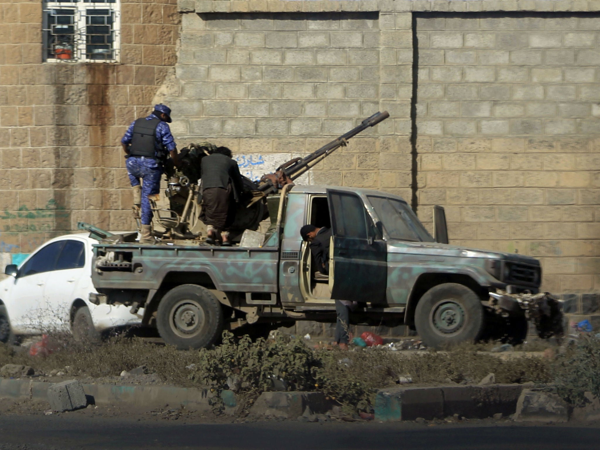 Houthi fighters man an anti-aircraft gun in the Yemeni capital Sanaa amid clashes with supporters of Yemeni ex-president Ali Abdullah Saleh