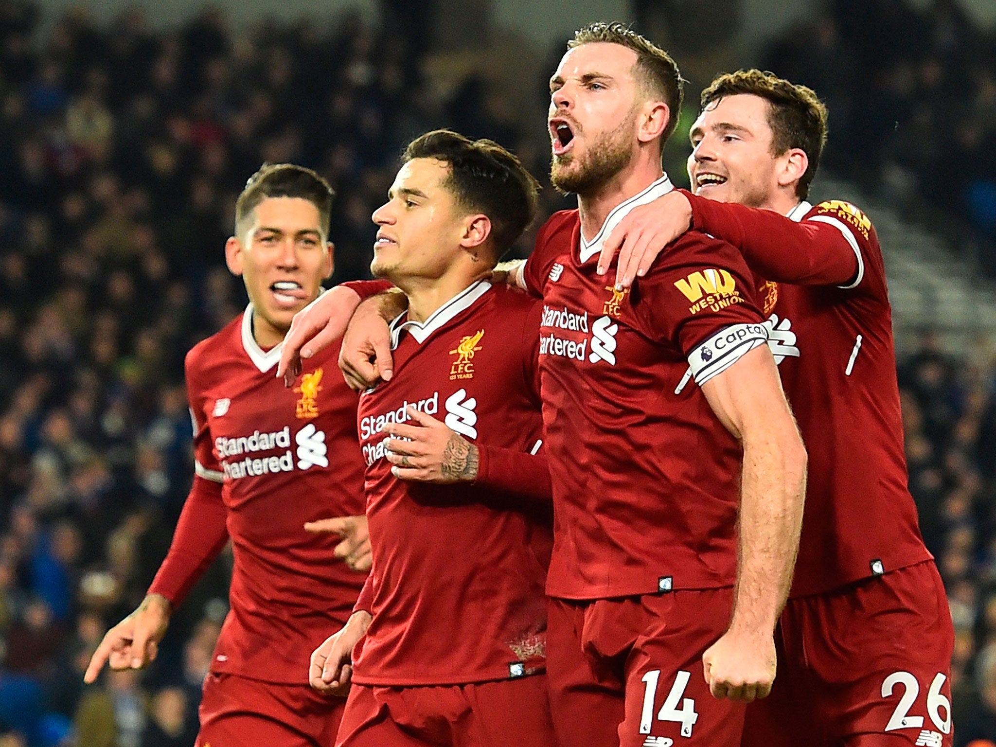 Jordan Henderson celebrates with teammates after Philippe Coutinho's goal