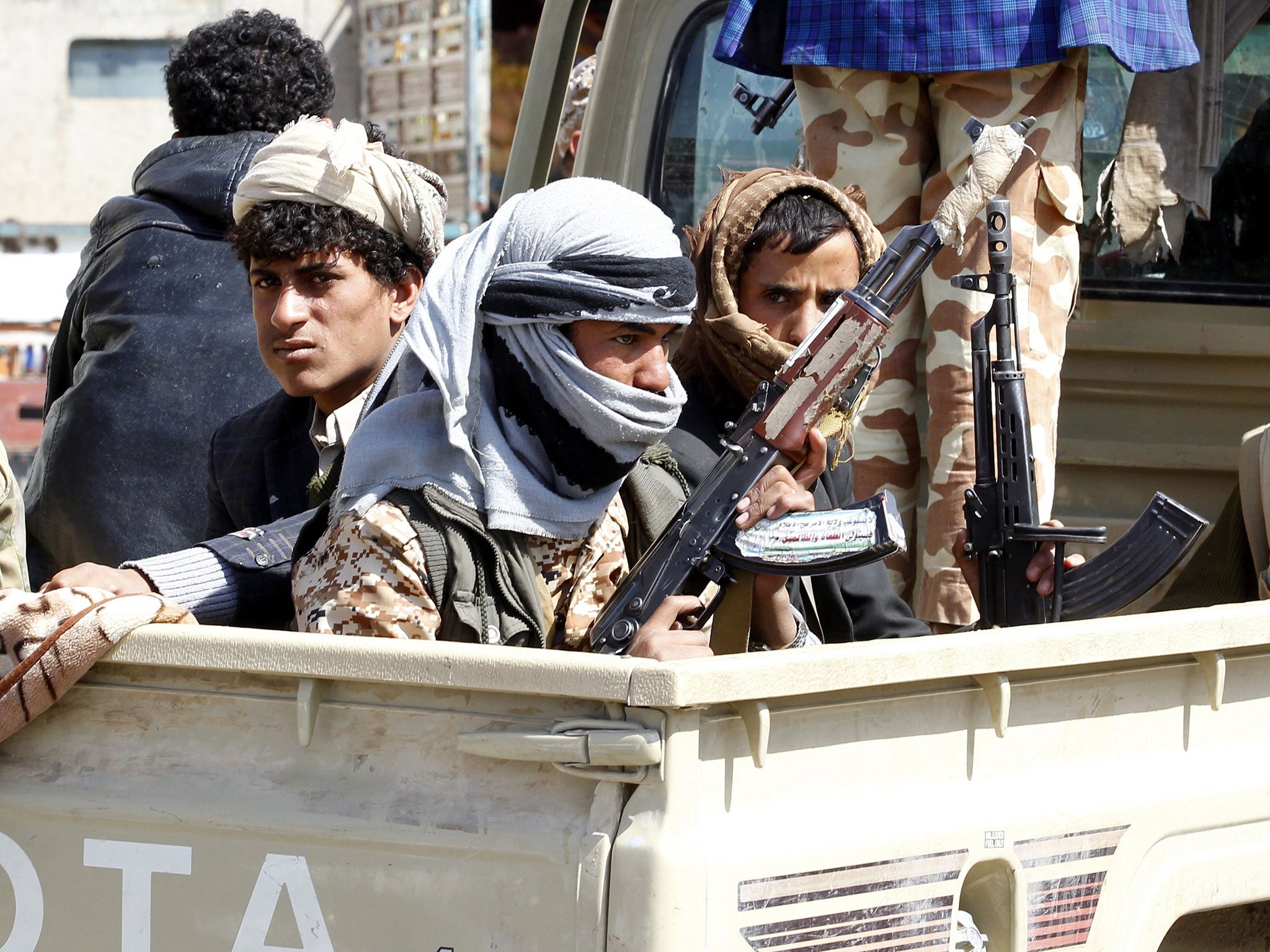 Houthi fighters ride a vehicle amid clashes between the Houthis and forces loyal to Yemen's ex-president Ali Abdullah Saleh, in Sanaa