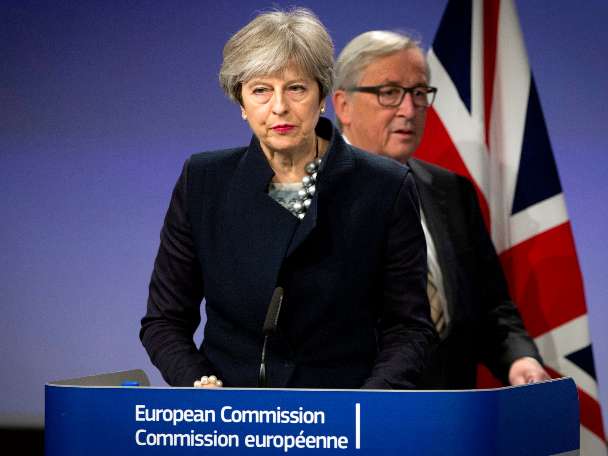 Jean-Claude Juncker walks behind Theresa May