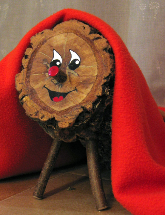 Tió de Nadal bundled in a blanket