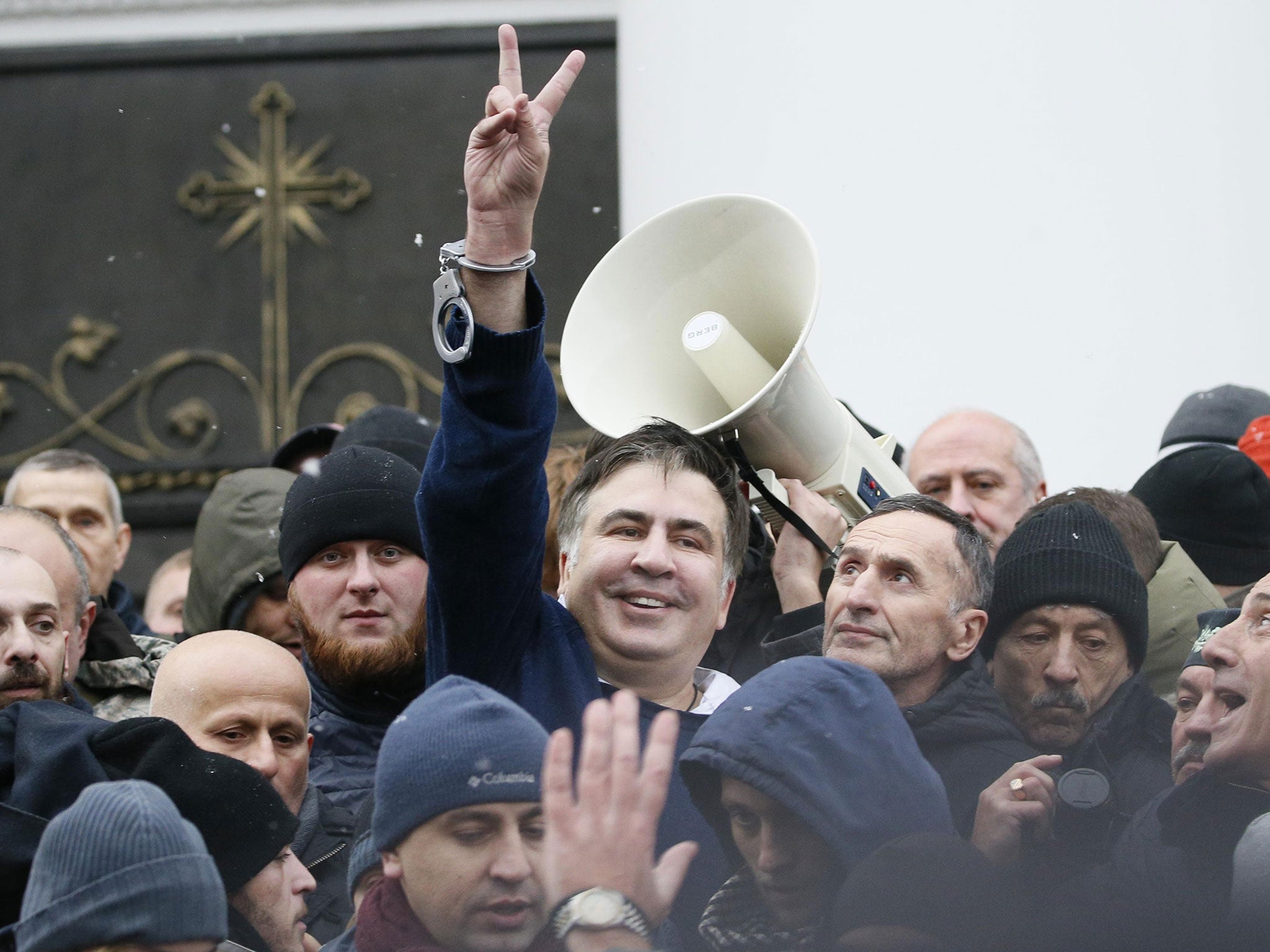 Saakashvili flashes a victory sign after he was freed by his supporters in Kiev