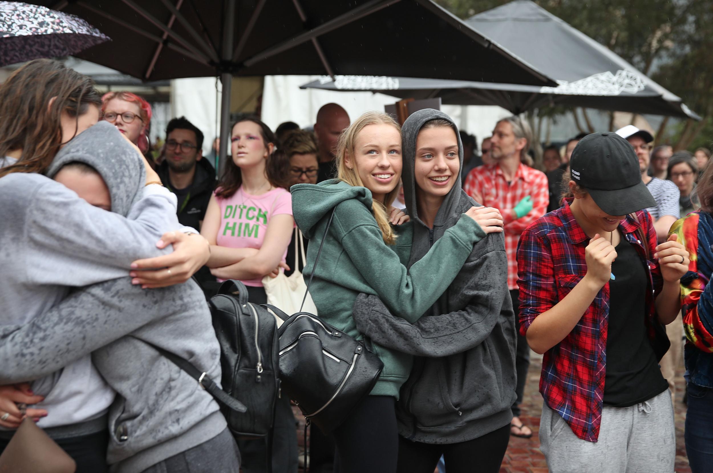 A group of women celebrate as react as they watch the announcement of the legalisation of same-sex marriage on a large television screen in Melbourne's Federation Square