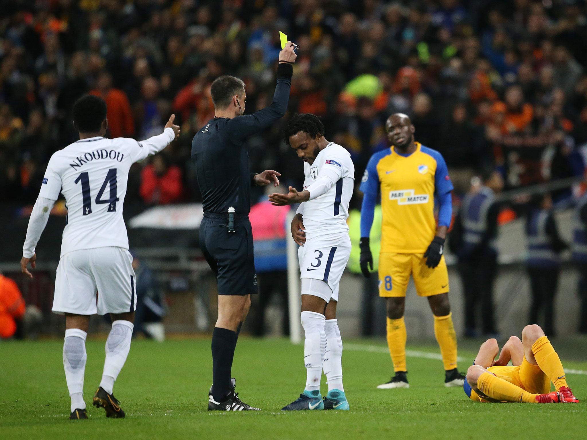 Danny Rose is shown a yellow by referee Slavko Vincic