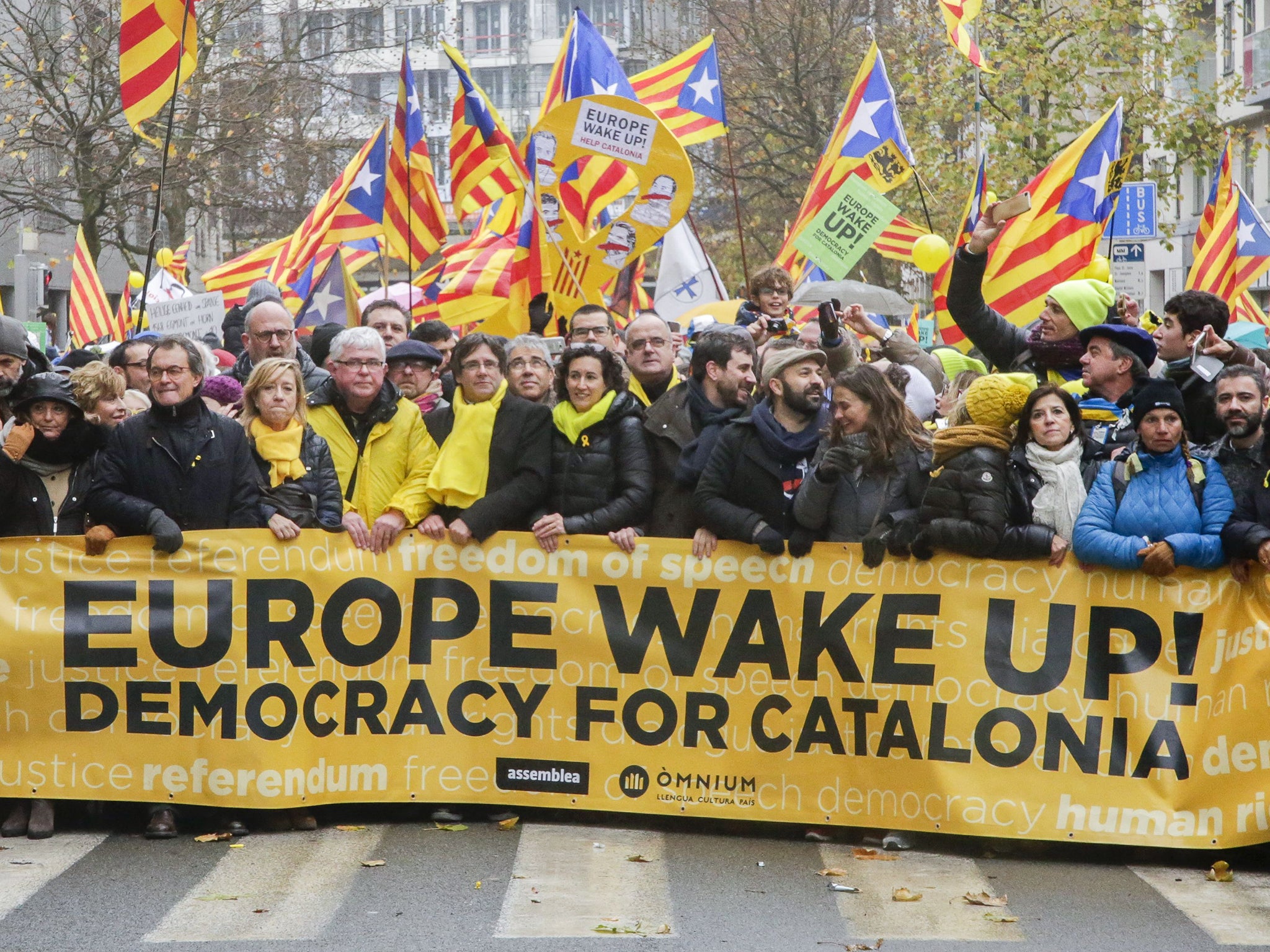 Catalan leader in exile, Carles Puigdemont (5th from left in yellow scarf), at the Independence of Catalonia protest (Rex)