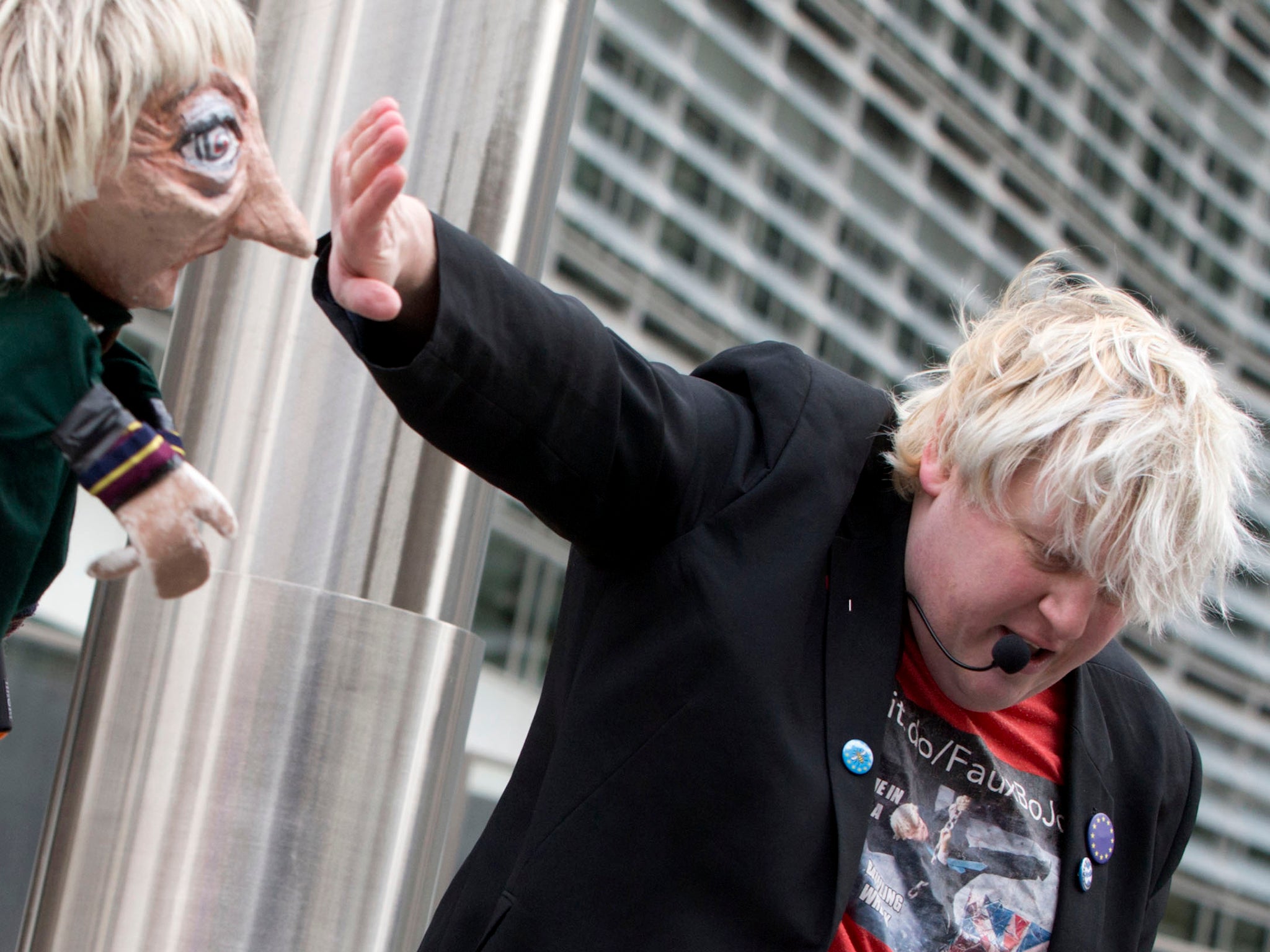 A man imitating Boris Johnson plays in a skit with a puppet of Theresa May outside EU headquarters in Brussels last week