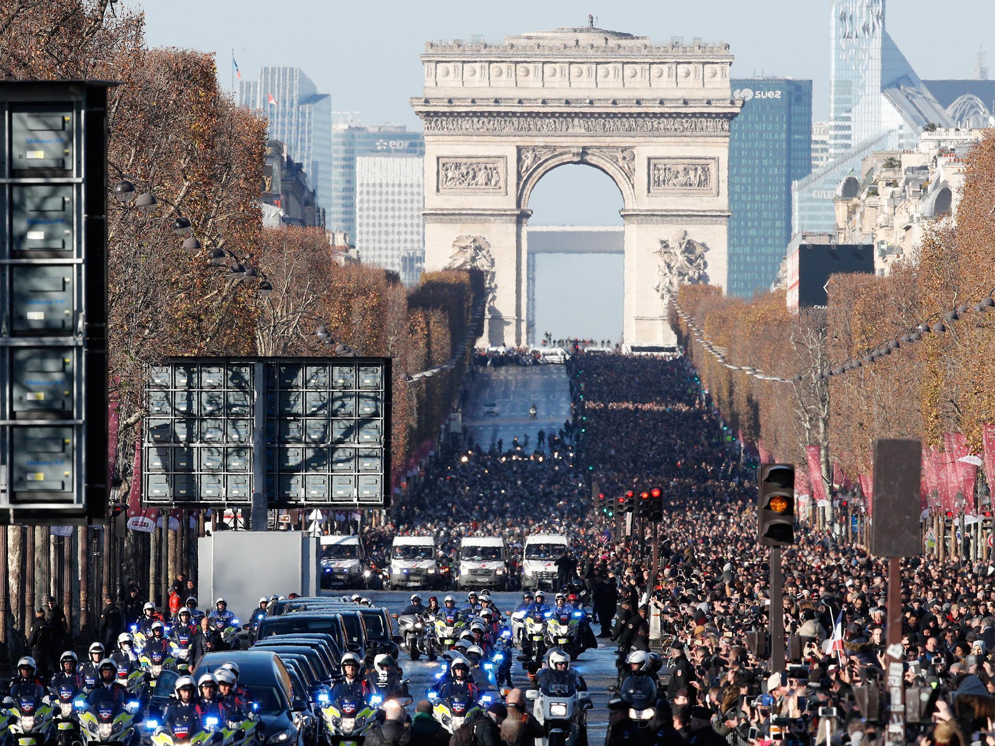 A motorcycle parade in the French capital follows the hearse carrying rock legend Hallyday