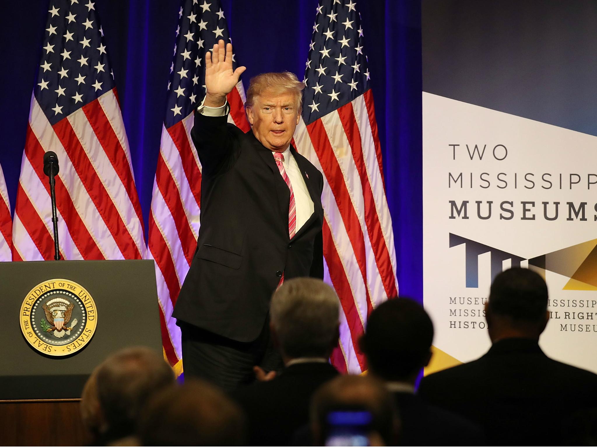 President Donald Trump waves after speaking following a tour of the Mississippi Civil Rights Museum on 9 December 2017 in Jackson, Mississippi.