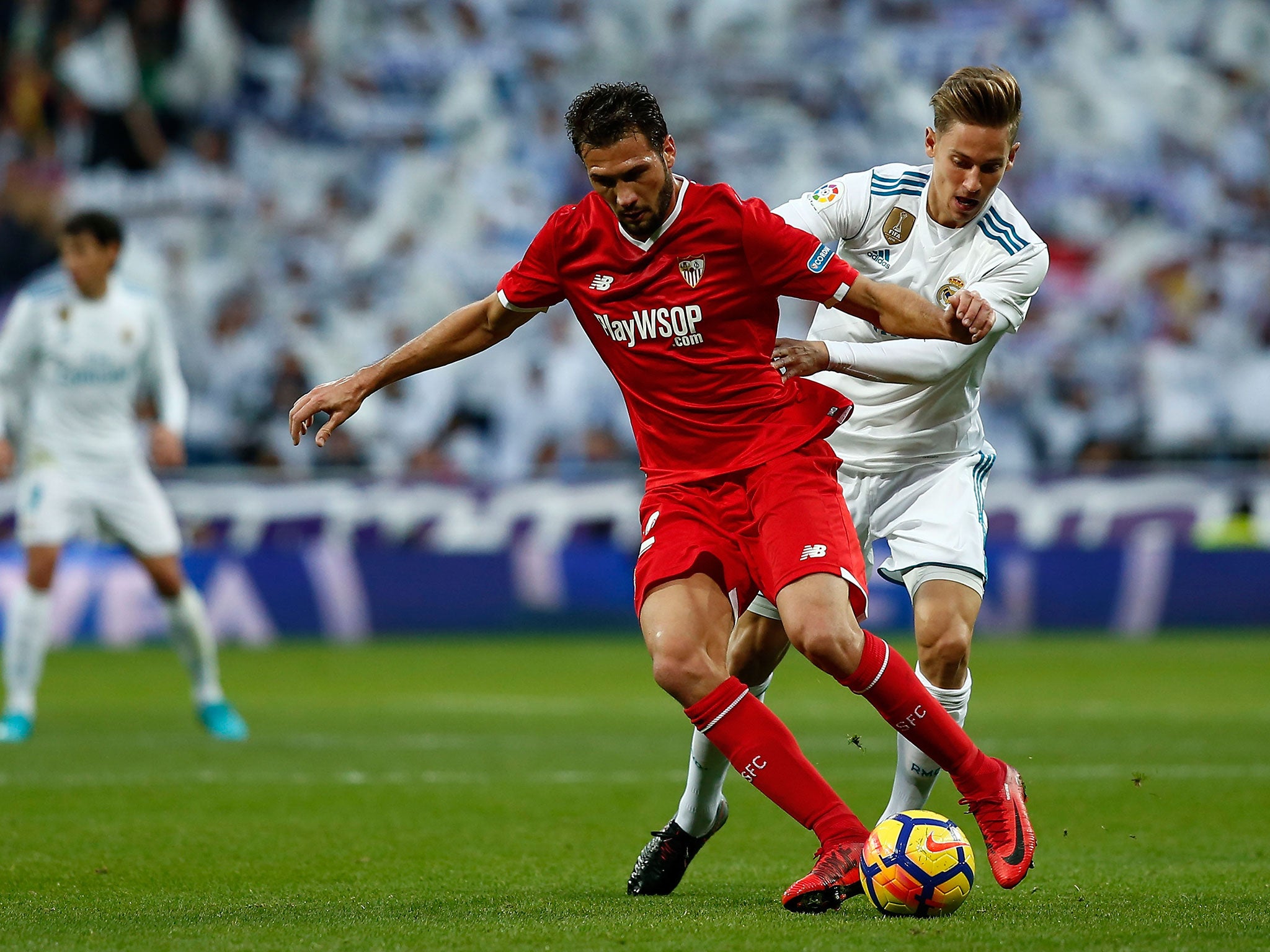 Marcos Llorente and Franco Vazquez tussle for possession