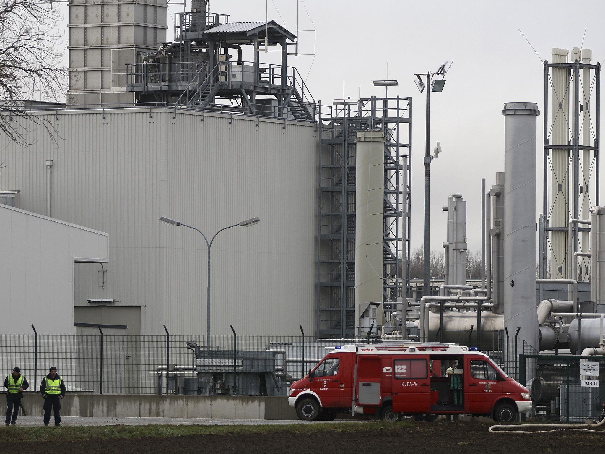 Firefighters stand outside a gas plant after an explosion occurred near Baumgarten an der March, Germany