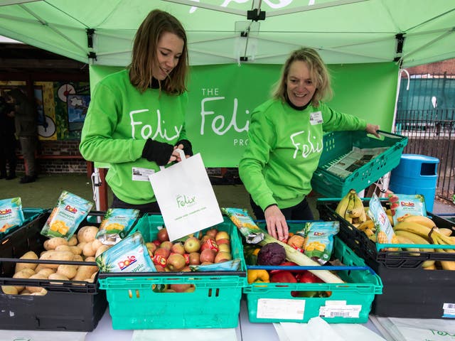 Felix volunteers load up bags of produce for children and their parents at Stanhope primary