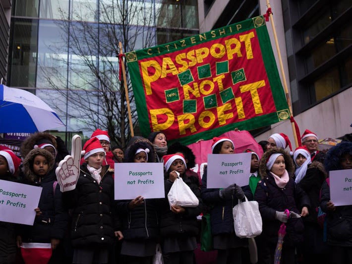 Revd Mother Ellen Eames and school children singing carols outside the Home Office. Hundreds delivered Christmas cards to Secretary of State Amber Rudd asking her to cut the cost of British Citizenship