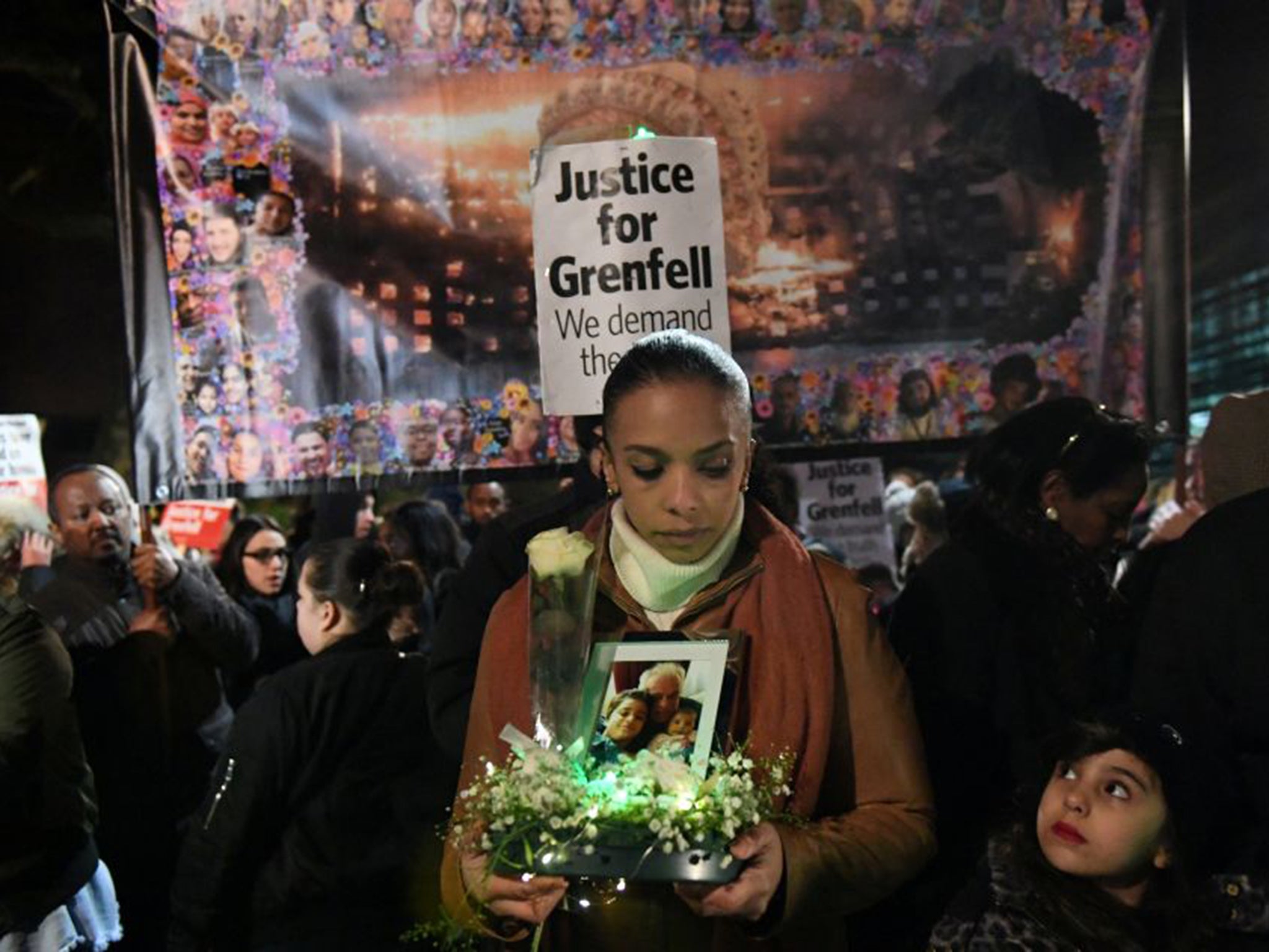 A woman pays her respects at a silent candlelit march for Grenfell.