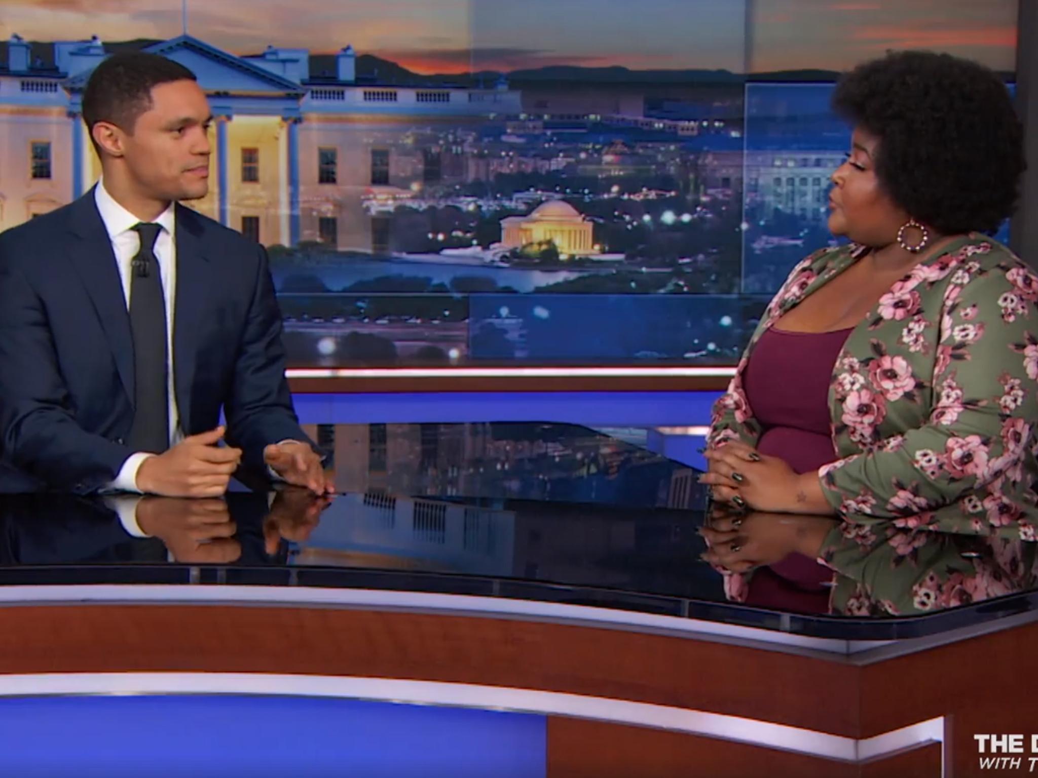 Trevor Noah (left) talks with Dulce Sloan about the Senate race in Alabama.