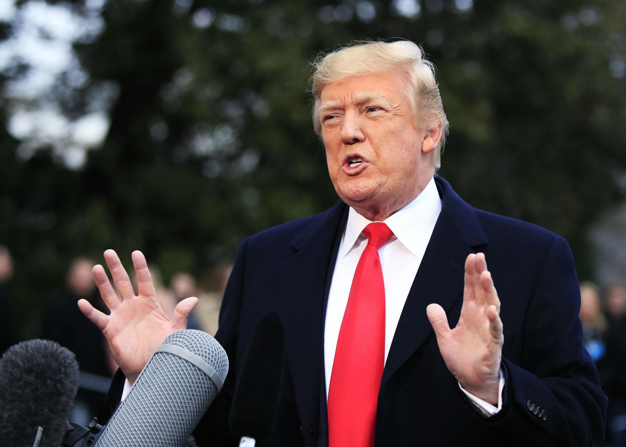 President Donald Trump speaks to reporters before leaving the White House in Washington, Friday, Dec. 15, 2017, for a trip to Quantico, Virginia to attend the FBI National Academy graduation ceremony.