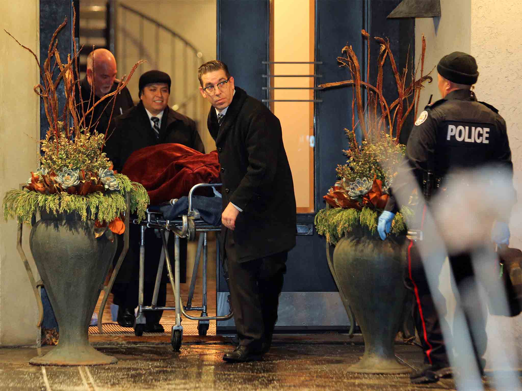 Bodies covered in blankets were removed from the Shermans' home on Friday