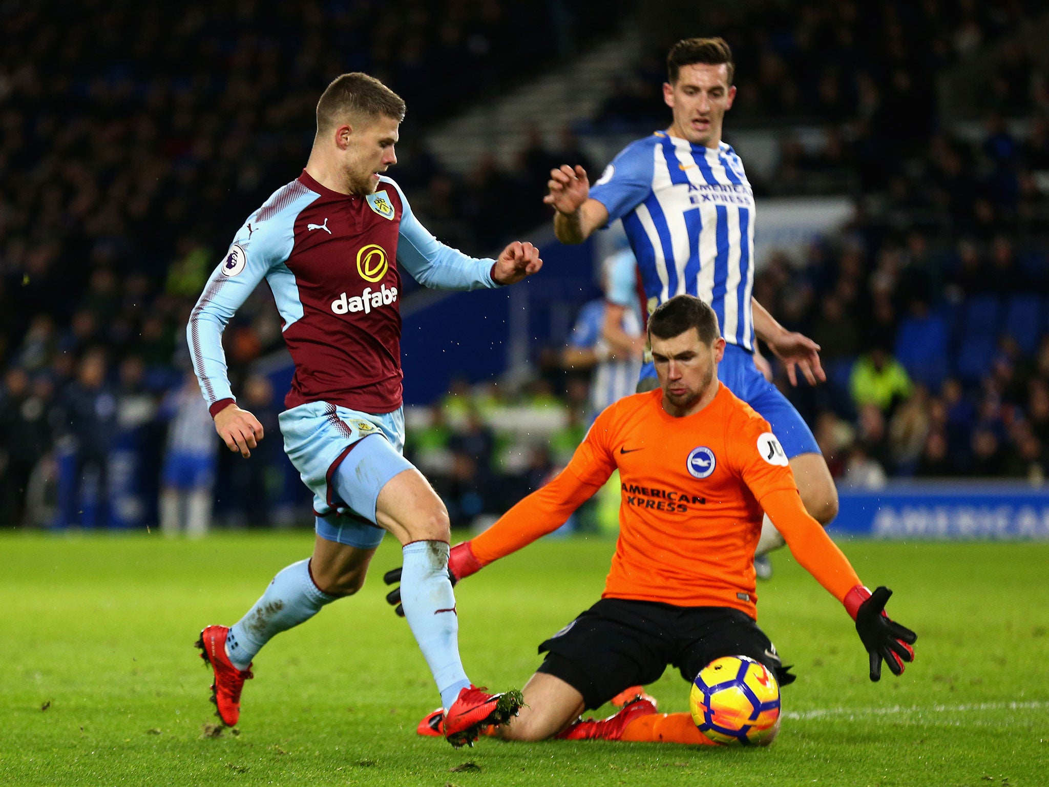 Johann Gudmundsson attempts to take the ball past Mathew Ryan