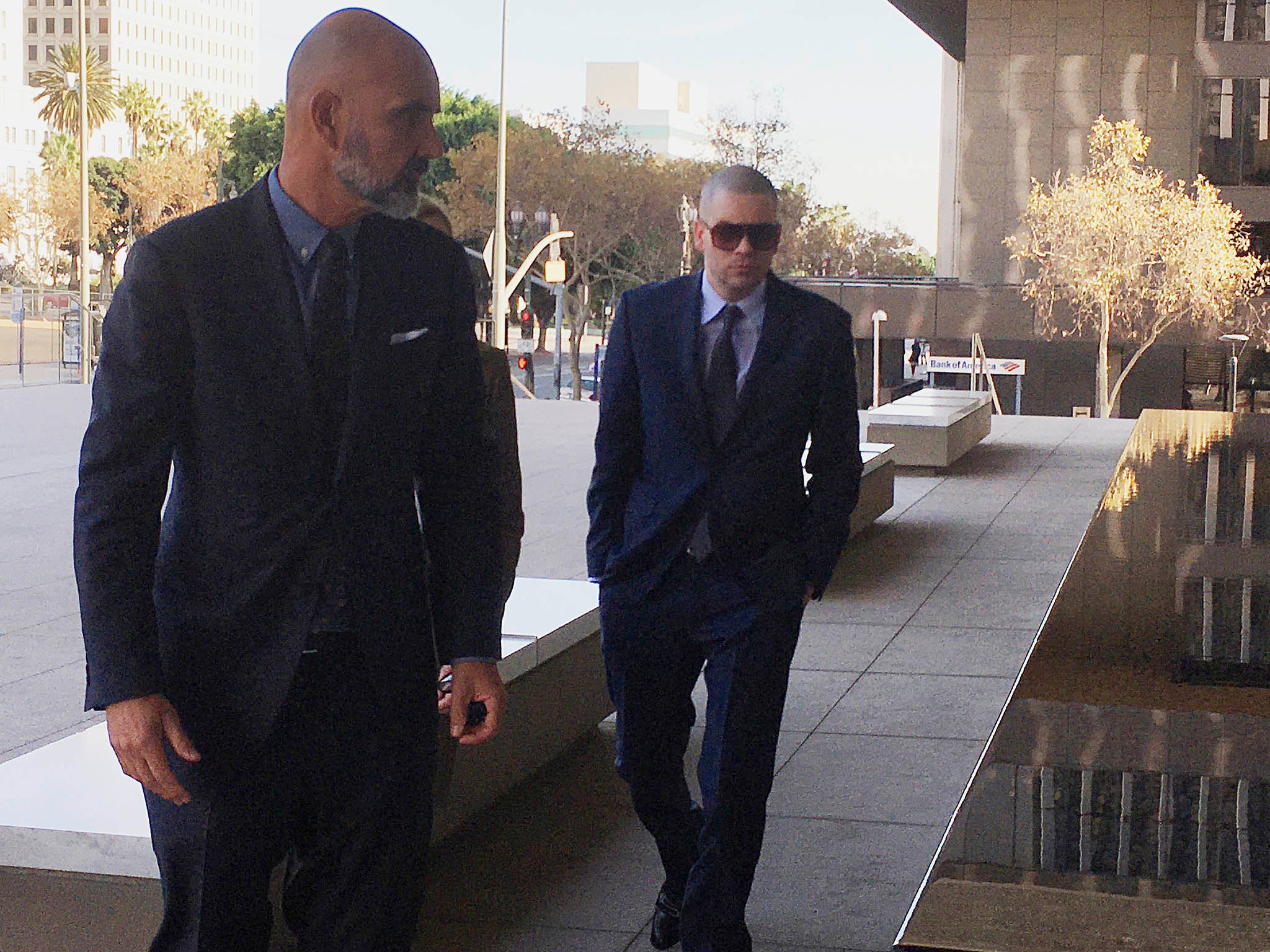 Former "Glee" actor Mark Salling, right, arrives at federal court in Los Angeles