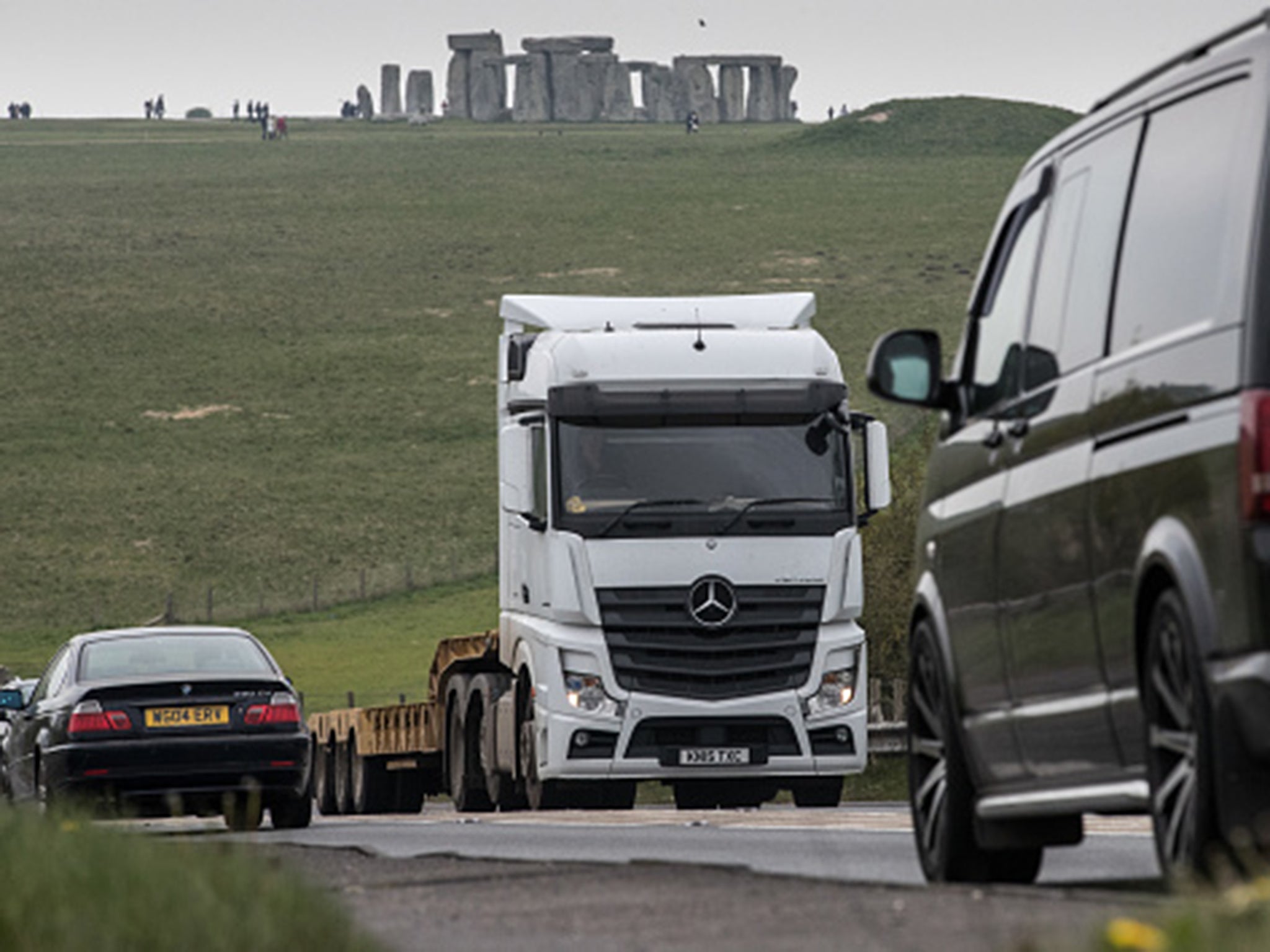 Traffic passes along the busy A303 that currently runs besides the ancient neolithic monument