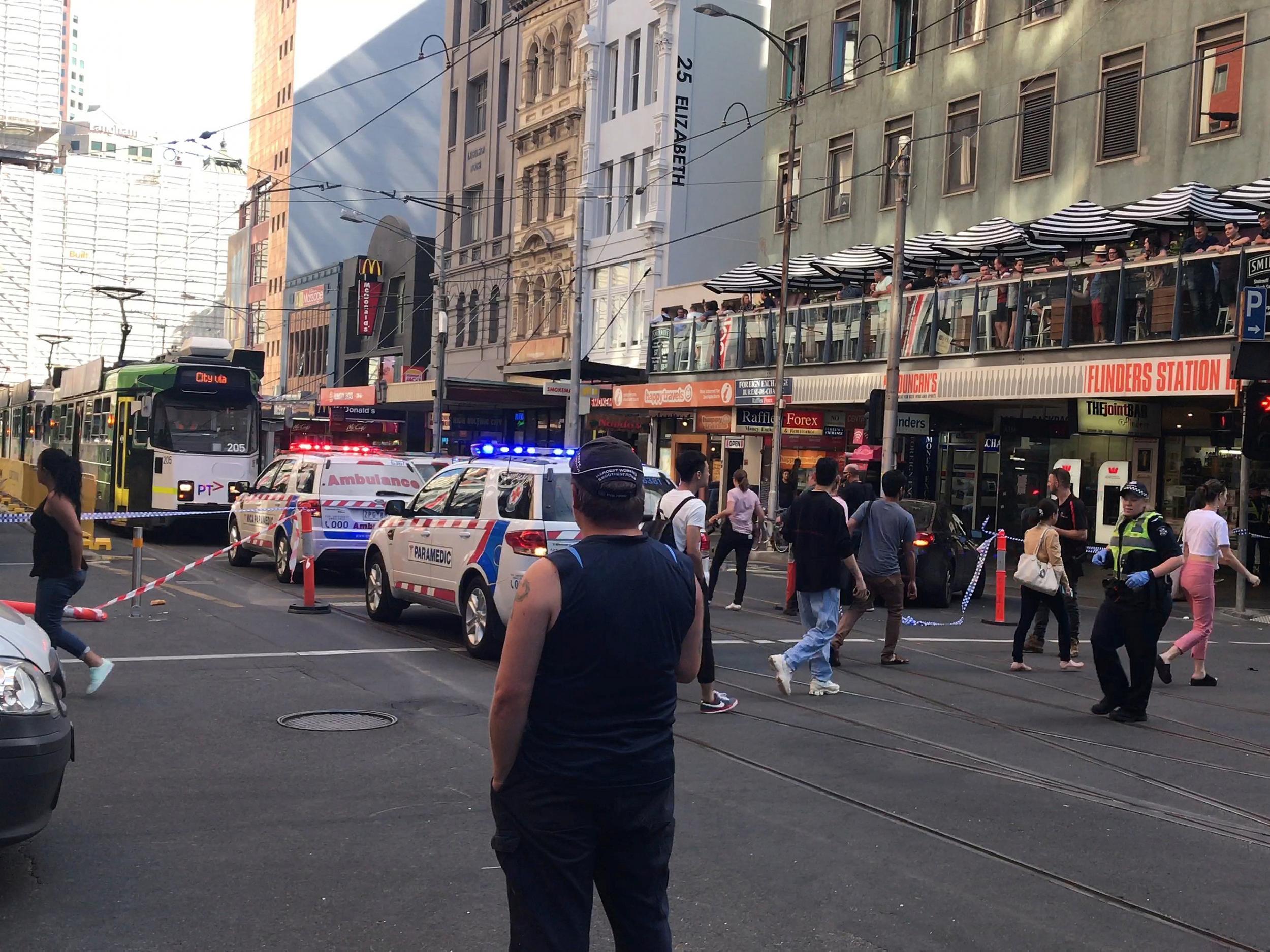 Police and emergency services attend the scene of the crash on Flinders Street