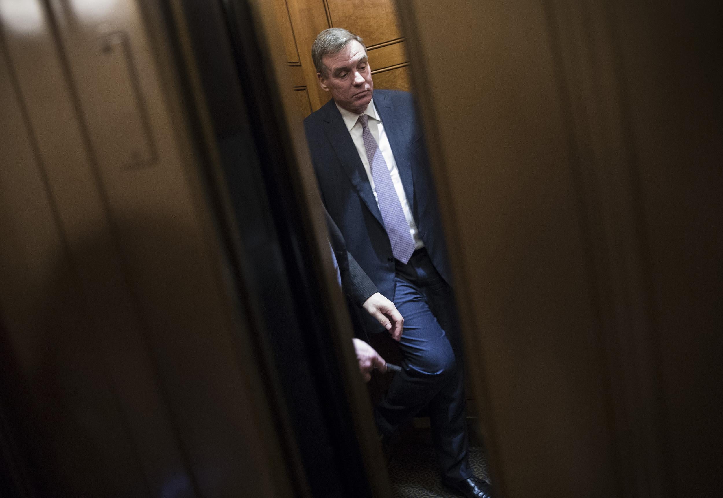 Senator Mark Warner boards an elevator after delivering a speech in the Senate chamber