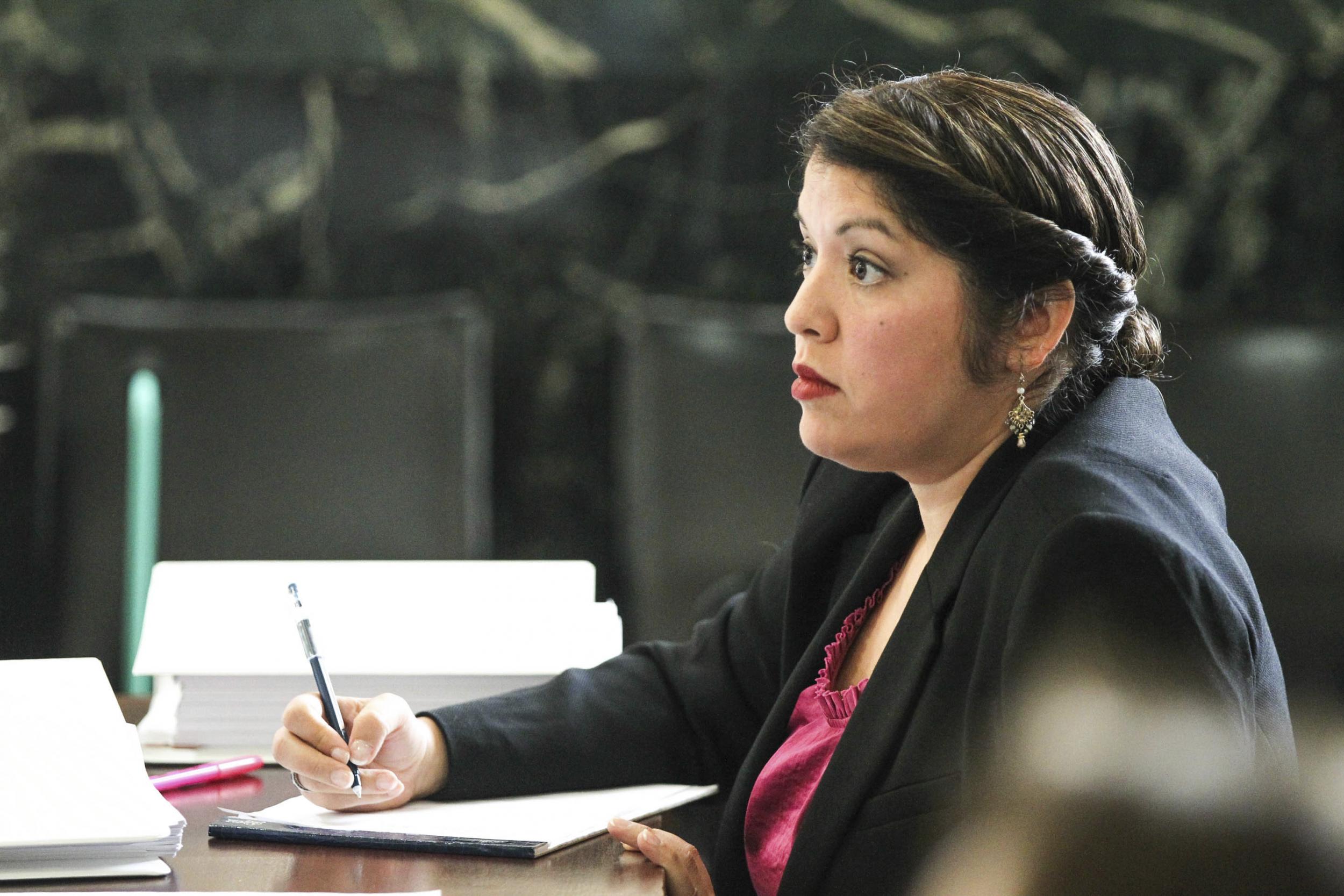 Monika Burgett listens to opening statements during her trial in Cincinnati.