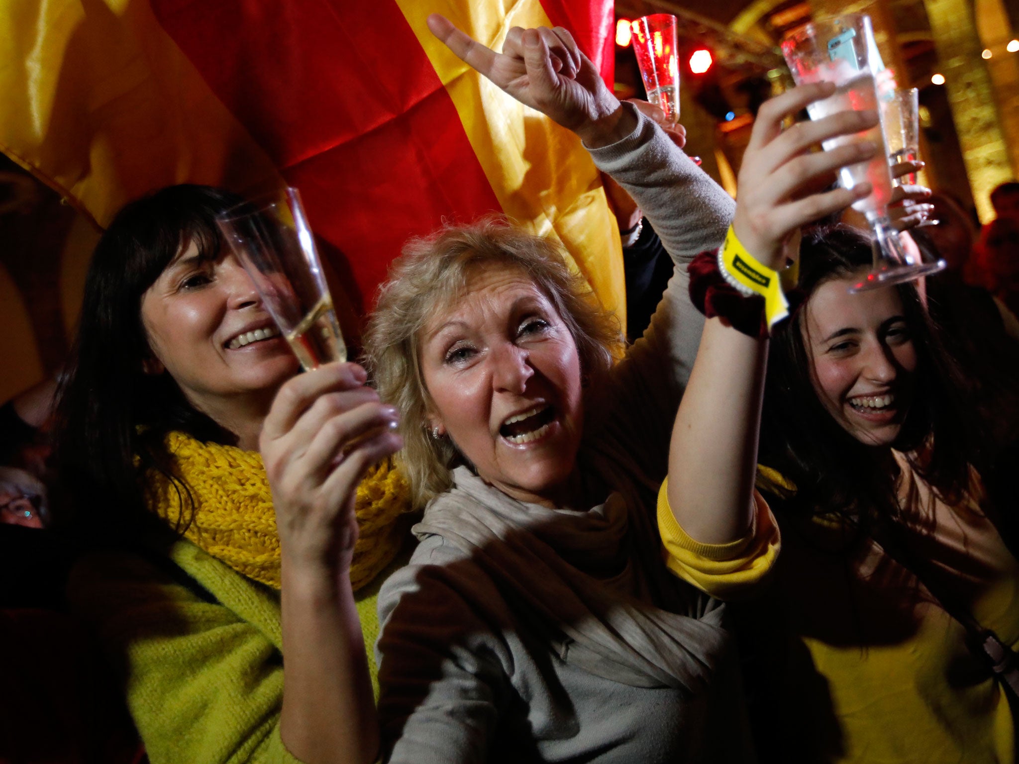 Catalan independence supporters toast as they celebrate results of the regional elections in Barcelona